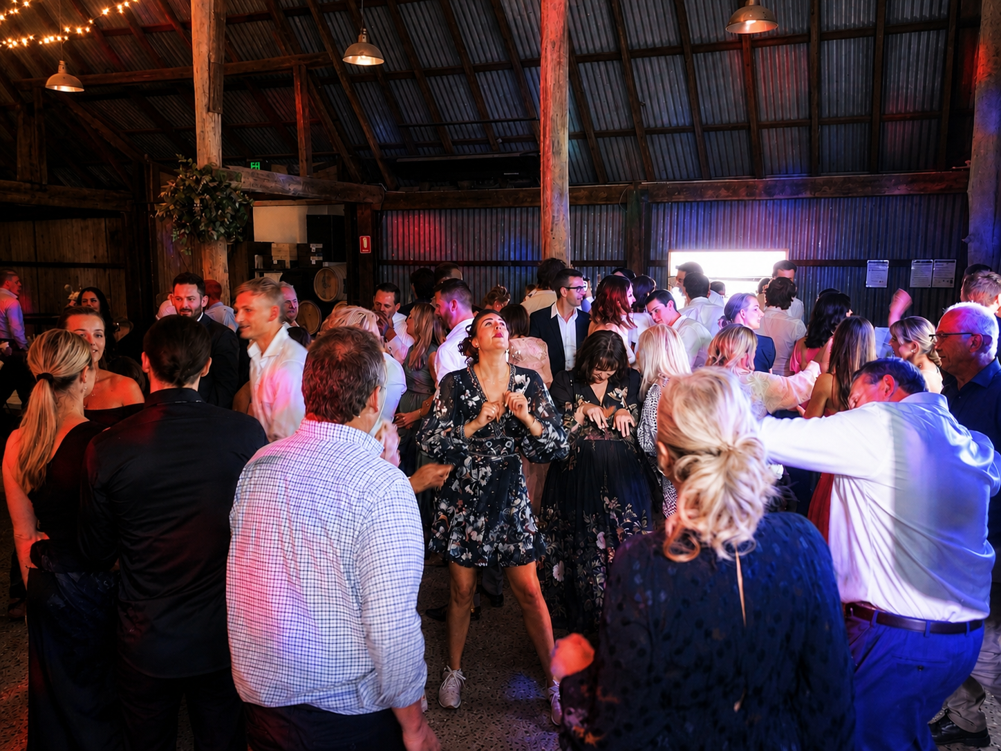 Guests filling the dancefloor at rustic barn wedding reception Melbourne