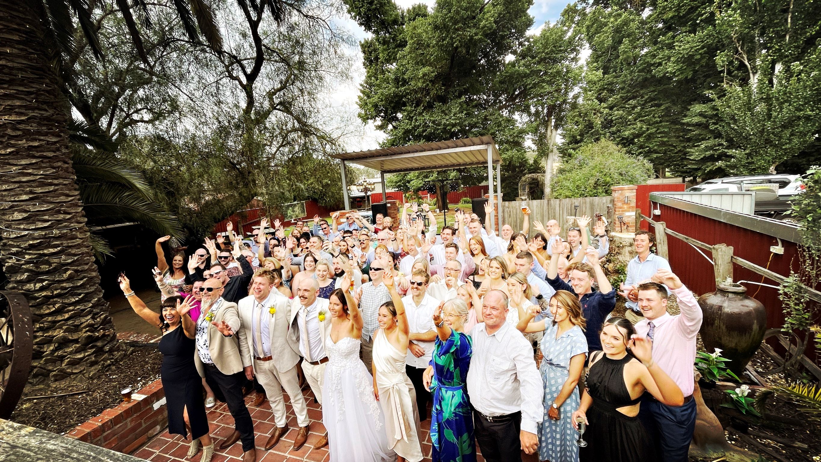 Full wedding party group photo outdoors at Melbourne wedding celebration